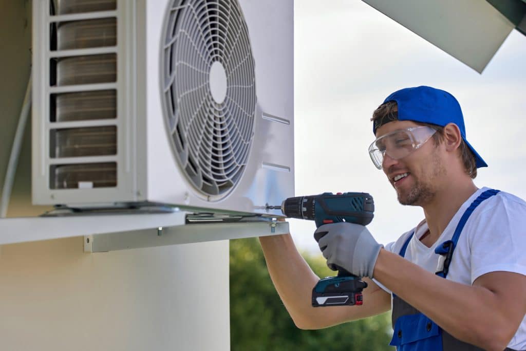 worker installs the air conditioner